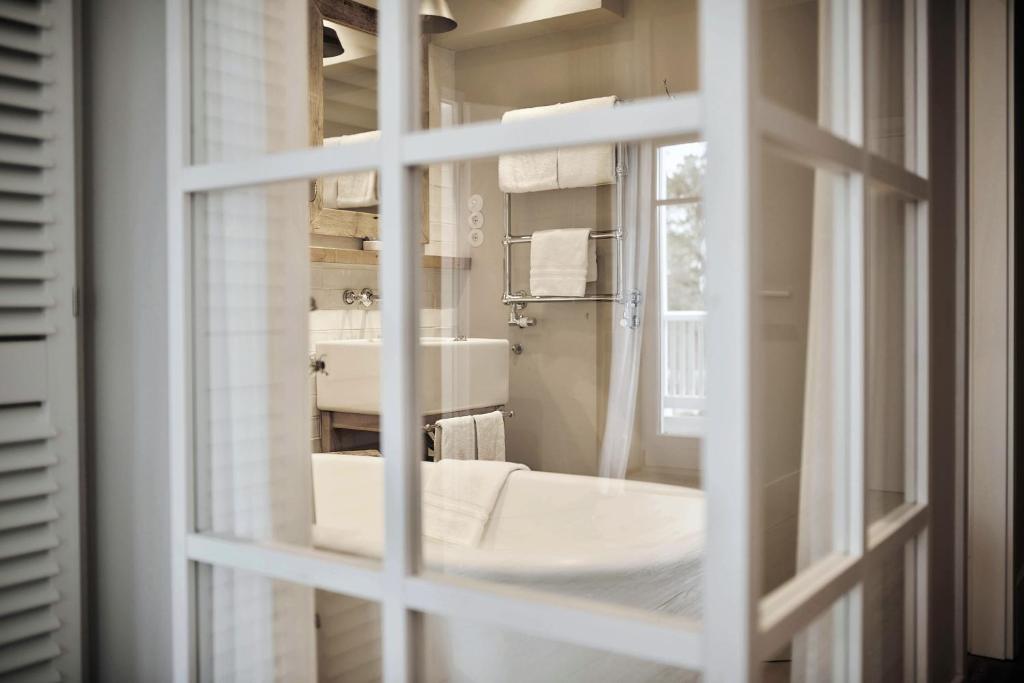 a bathroom with a sink and a mirror at The Cozy Hotel & Lofts Timmendorfer Strand in Timmendorfer Strand