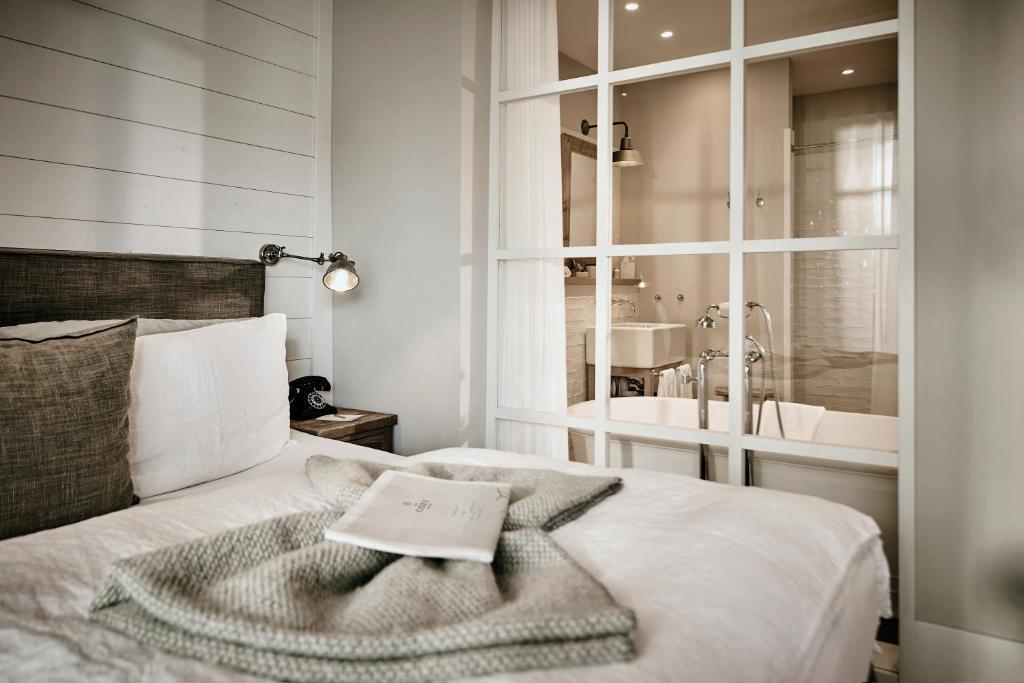 a bedroom with a bed with a towel on it at The Cozy Hotel & Lofts Timmendorfer Strand in Timmendorfer Strand