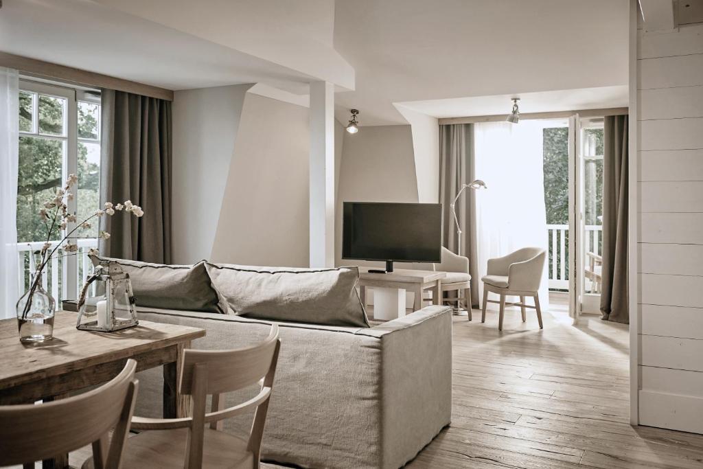 a living room with a couch and a table at The Cozy Hotel & Lofts Timmendorfer Strand in Timmendorfer Strand