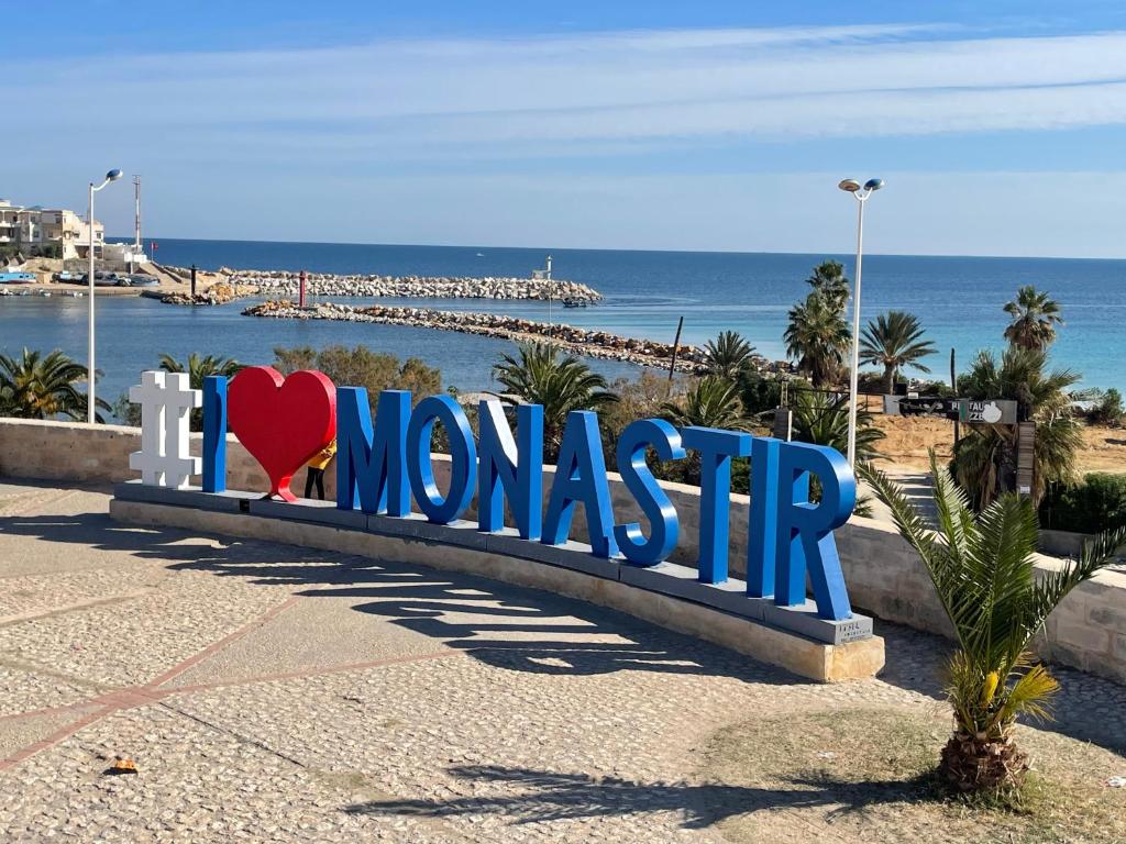 a sign that says i love mongolia next to the beach at Monastir Bord de Mer Palais Présidentiel in Monastir