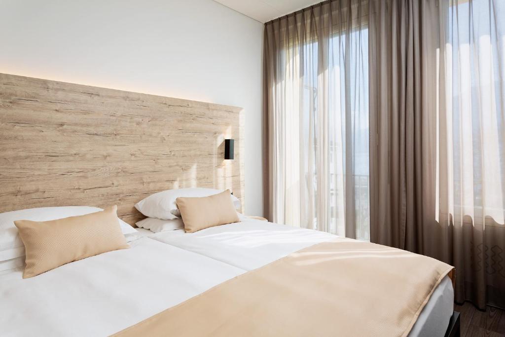 Postel nebo postele na pokoji v ubytování Hotel Du Lac