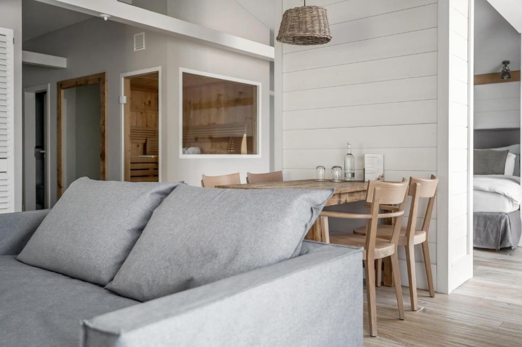 a living room with a couch and a table at The Cozy Hotel & Lofts Timmendorfer Strand in Timmendorfer Strand