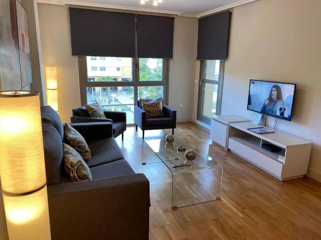 Televízia a/alebo spoločenská miestnosť v ubytovaní Playa Pacífico Apartment