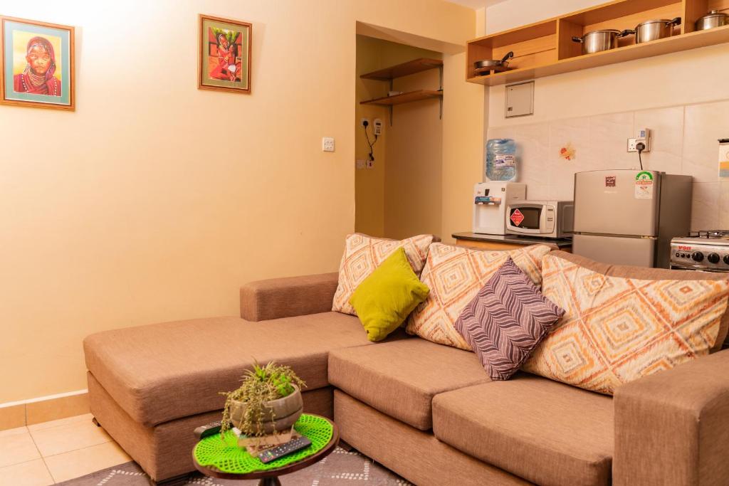 a living room with a couch and a refrigerator at Sherry Homes - Raha in Nairobi