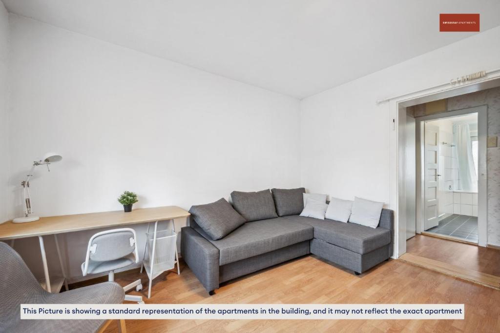 a living room with a couch and a table at Apartment in the heart of Oerlikon in Zurich