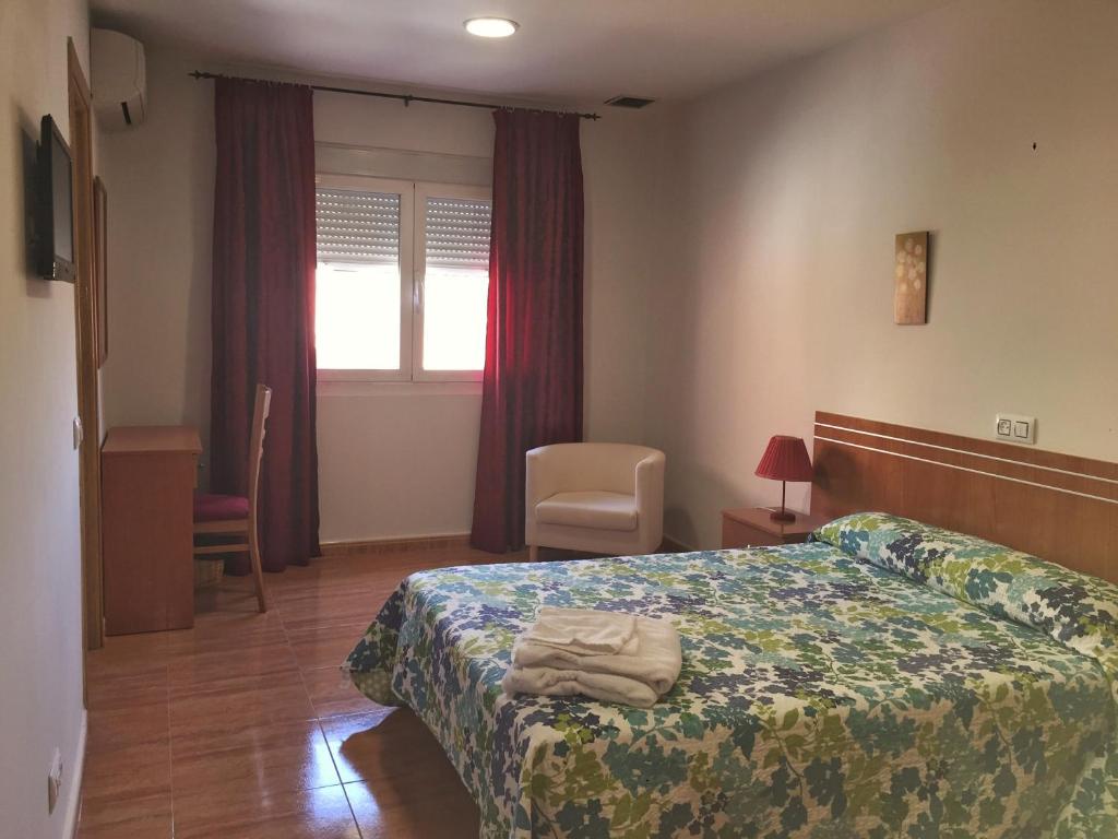 Posteľ alebo postele v izbe v ubytovaní Hotel Godofredo