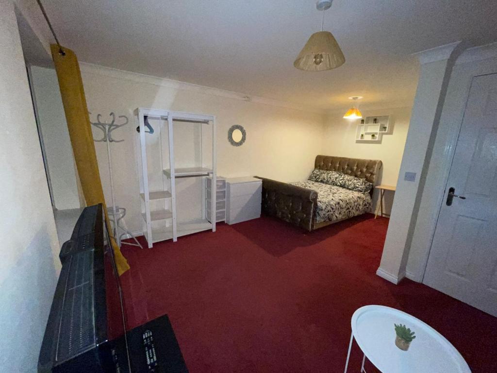 a living room with a couch and a table at Room 2 - Chassagne Guest House in Church Coppenhall