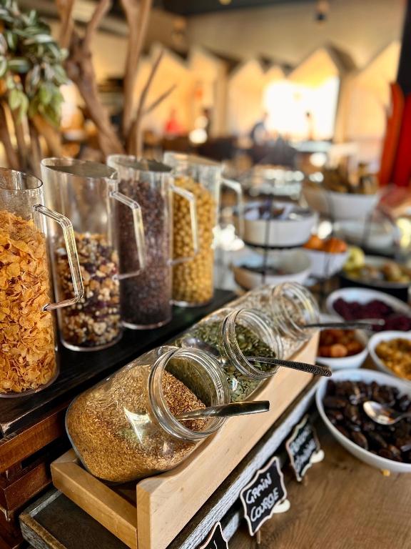 a buffet with many different types of food on a table at Hotel Base Camp Lodge - Albertville in Albertville