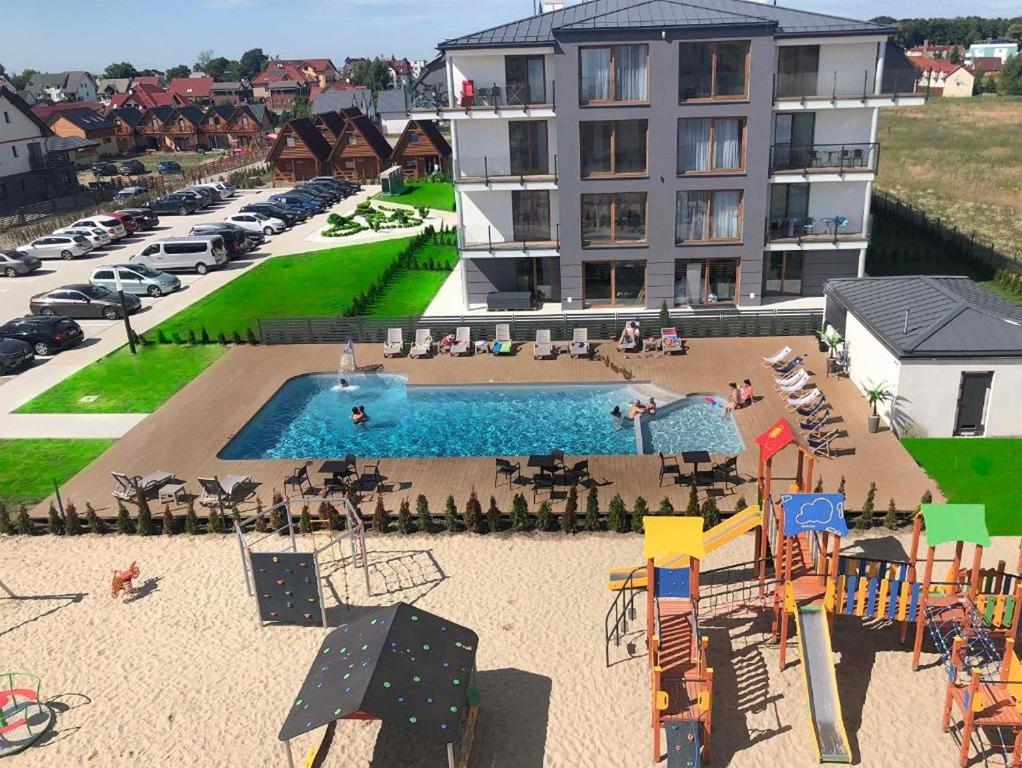 an aerial view of a playground in front of a building at Baltic Apartment Marynarska by Noclegi Renters in Sarbinowo