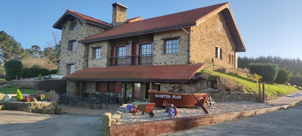 a large brick house with a toy train in front of it at QUINTES PLAYA in Villaviciosa