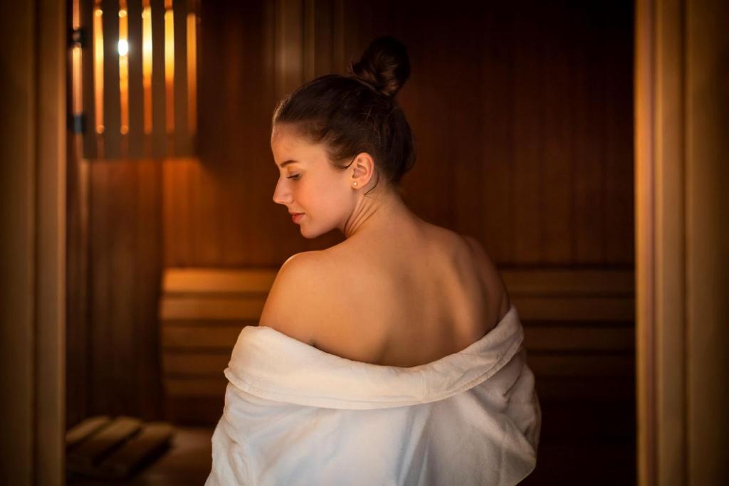 a woman in a wedding dress looking out a window at Valamar Diamant Hotel in Poreč