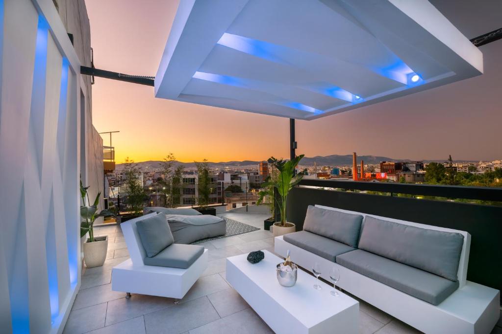 a balcony with couches and a view of a city at Live Your Myth in Thissio in Athens
