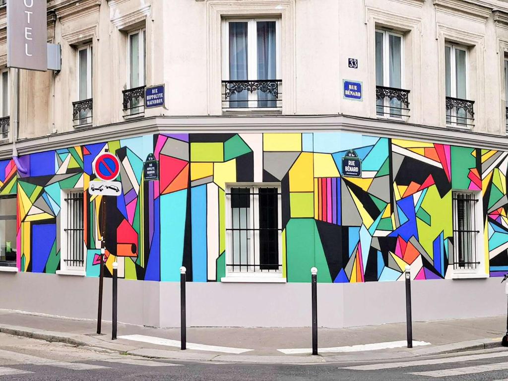 um edifício com um mural colorido ao lado em ibis Styles Paris Maine Montparnasse em Paris