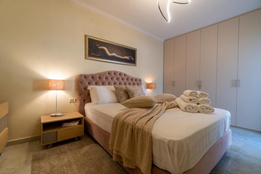 a bedroom with a large bed and a night stand at Sweet Luxury House in Alepou