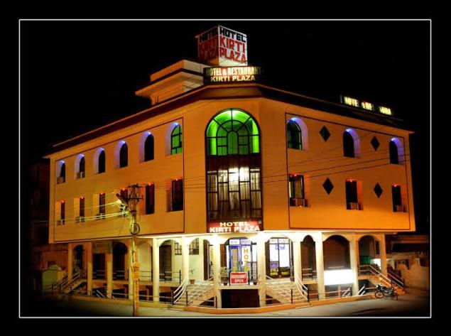 a building with a green light on top of it at Hotel Kirti Plaza in Chittaurgarh