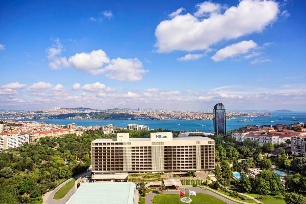 an aerial view of a large building with a city at Hilton Istanbul Bosphorus in Istanbul