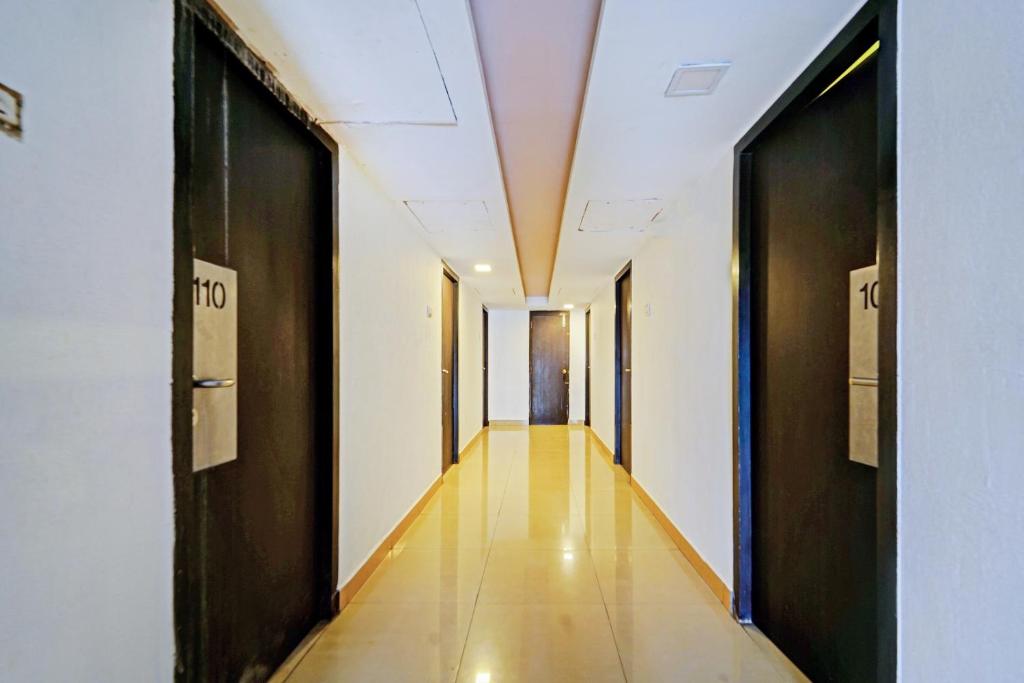 un pasillo en un edificio con puertas abiertas en Collection O 81666 Cedar Hotel, en Kāndūr