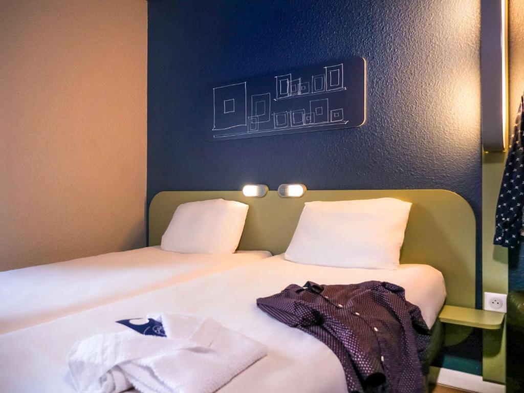 Postel nebo postele na pokoji v ubytování ibis budget Arles Sud Fourchon