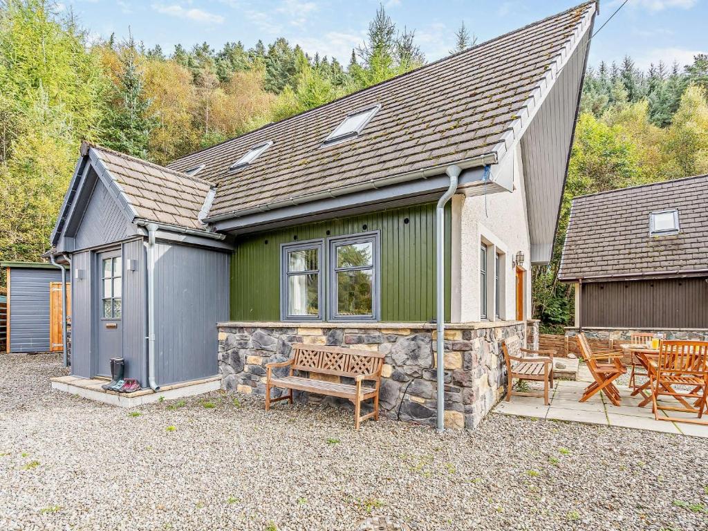 a house with a bench in front of it at 3 Bed in Callander 79359 in Callander