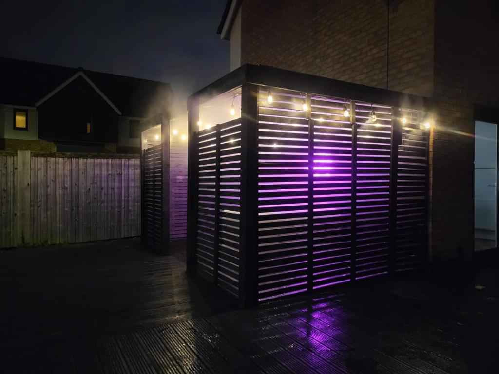 a lit up door with lights on the side of a building at Birmingham Airport Luxury3BRHOME in Marston Green