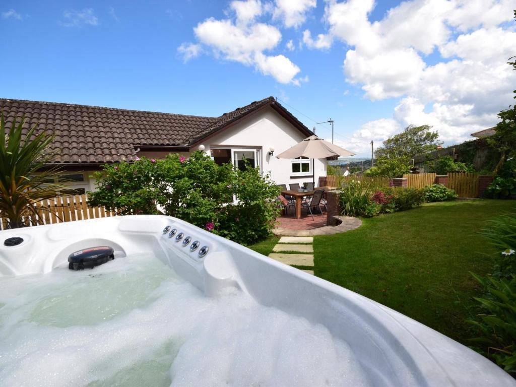 a jacuzzi tub in the backyard of a house at 4 Bed in Westward Ho 66659 in Northam