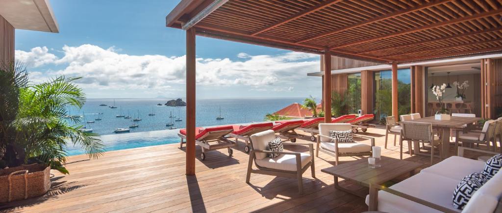 a patio with a view of the ocean with boats at Luxury Vacation Villa 4 in Gustavia