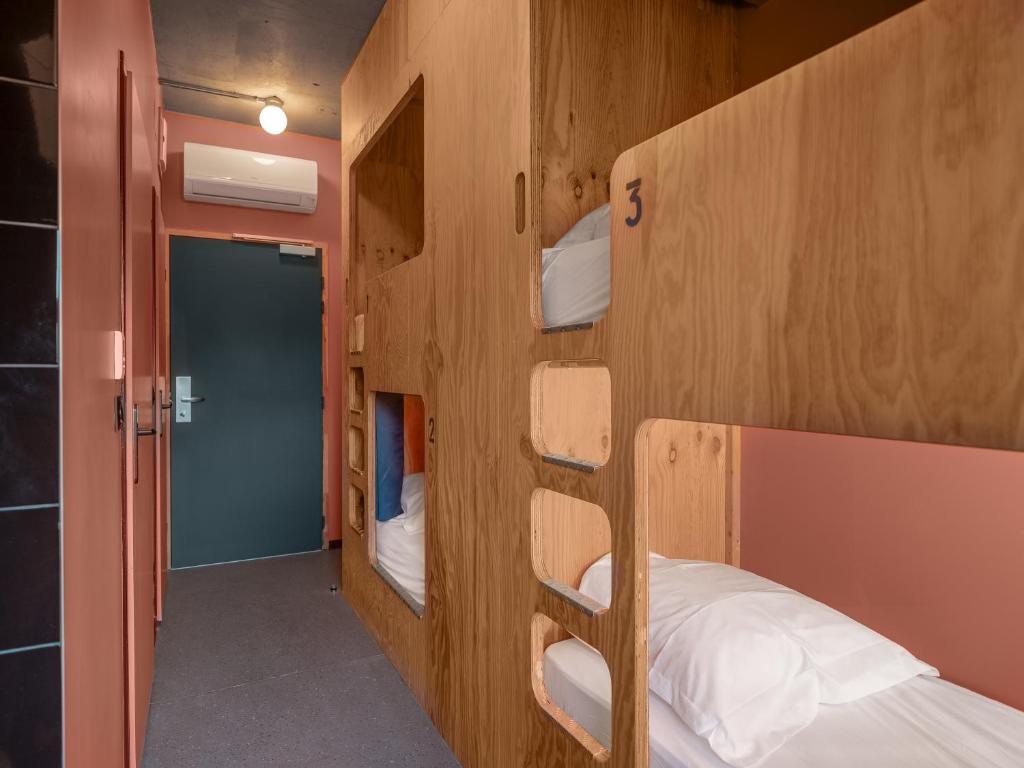 a room with three bunk beds and a hallway at Eklo Paris Expo Porte de Versailles in Vanves