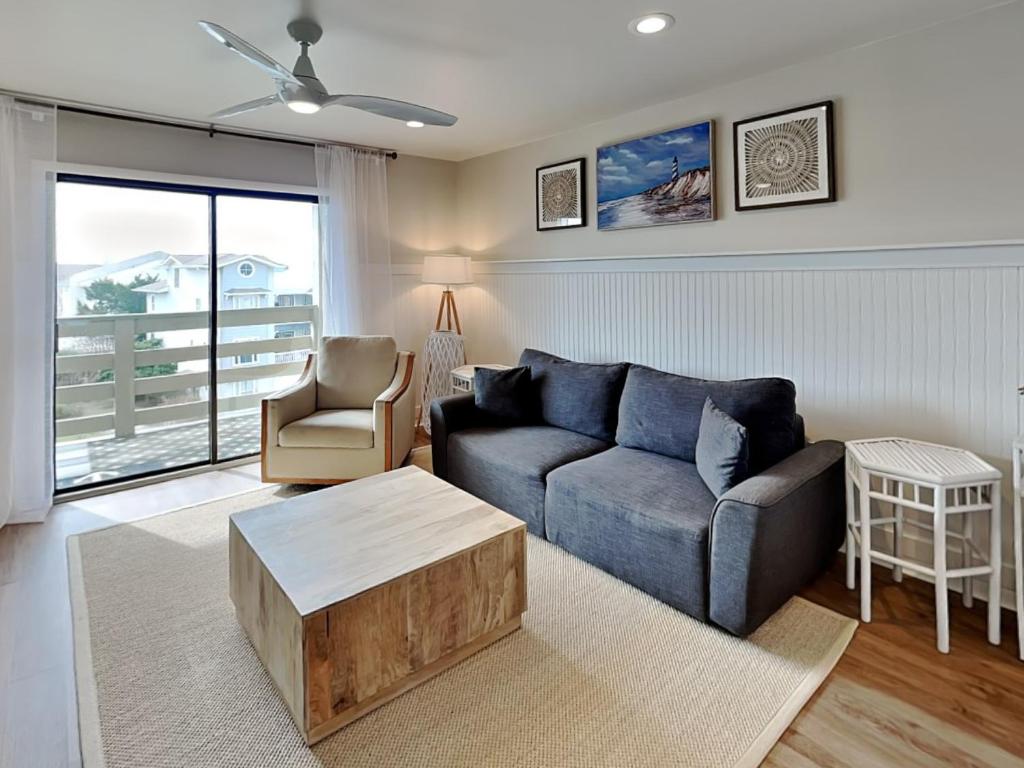a living room with a couch and a table at Lighthouse Point 7c in Tybee Island