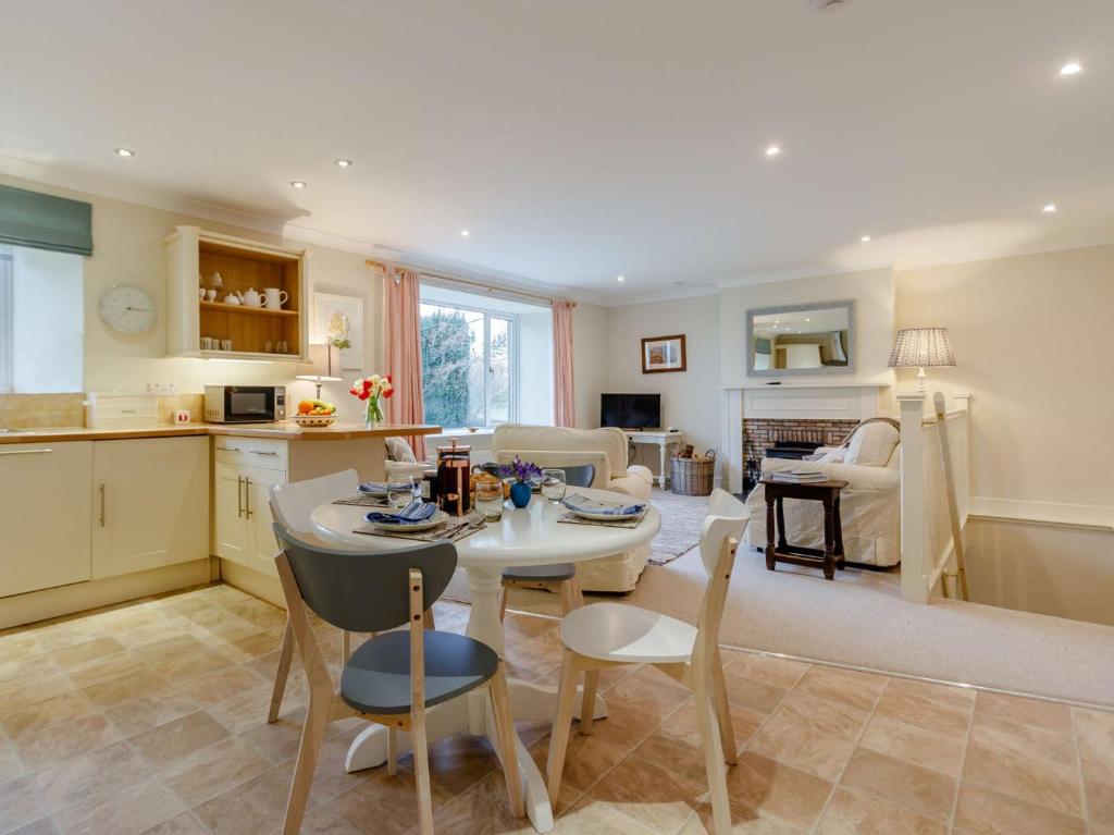 a kitchen and living room with a table and chairs at 2 Bed in Blair Drummond 81513 in Doune