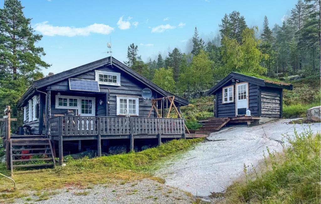 a log cabin with a deck and a house at Awesome Home In Fyresdal With Kitchen in Fyresdal