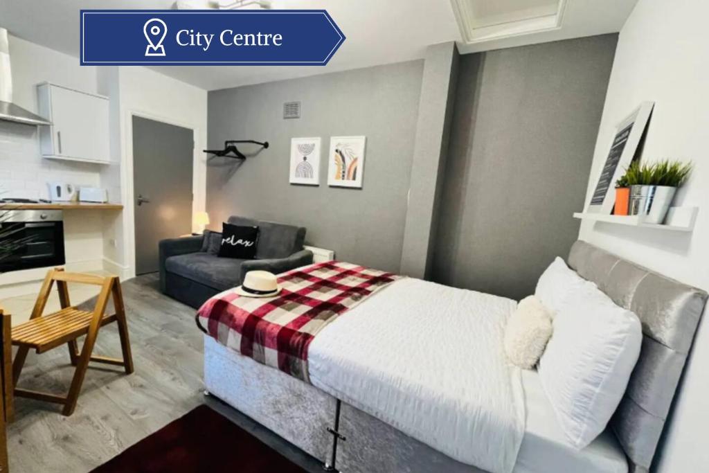 a small bedroom with a bed and a couch at Cosy Studio near the City Centre in Liverpool