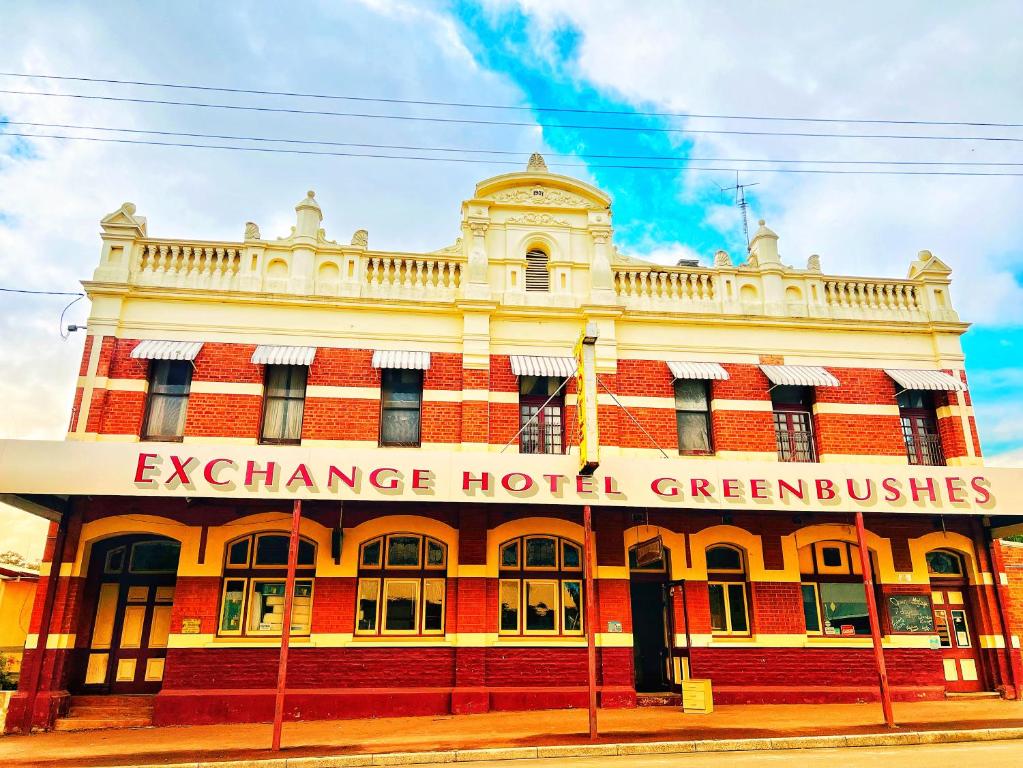 a large red and white building on a street at Exchange Hotel Greenbushes in Greenbushes