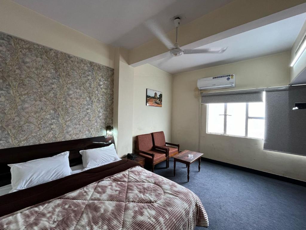 Postel nebo postele na pokoji v ubytování Gautam Hotel