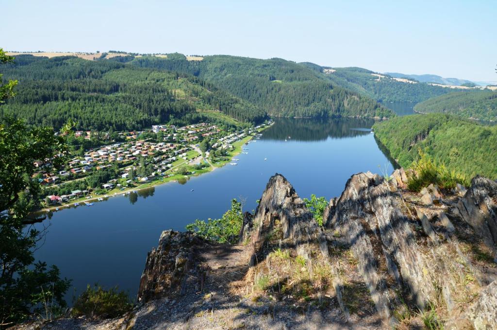 an aerial view of a lake with mountains at Hotel Am Schlossberg in Ziegenrück