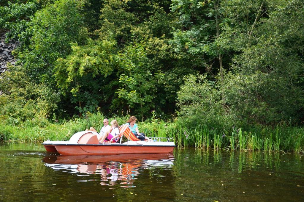 a group of people in a small boat on the water at Hotel Am Schlossberg in Ziegenrück