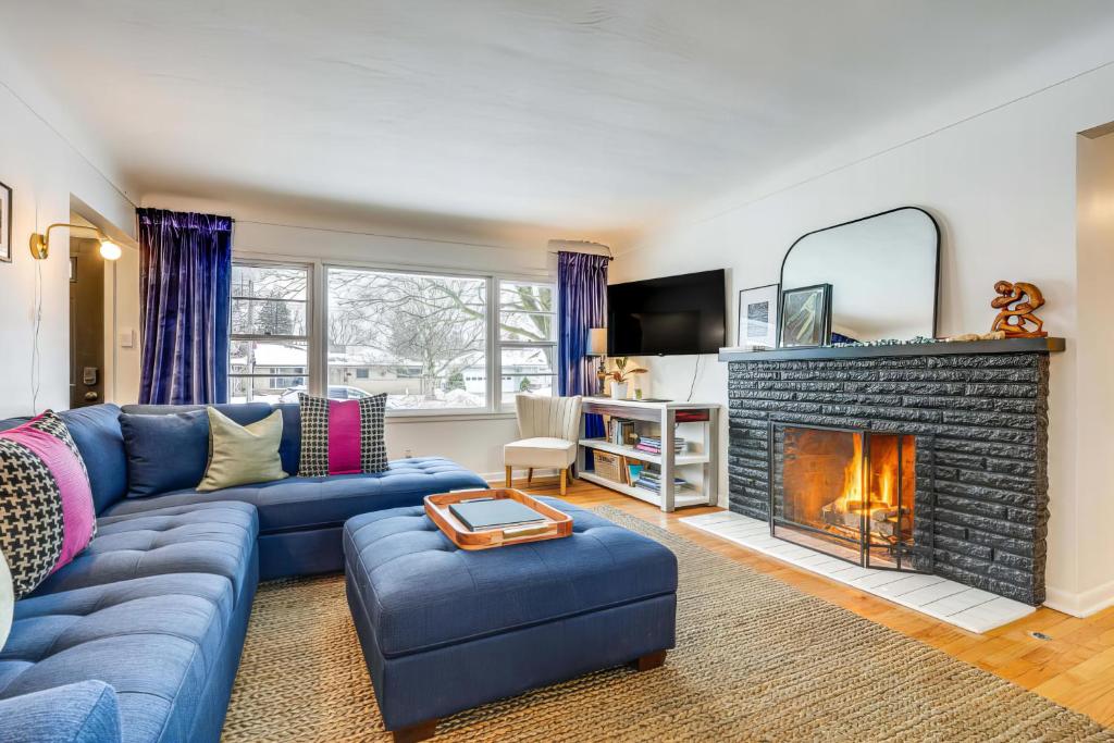 a living room with a blue couch and a fireplace at Wicks Home - Desirable Neighborhood Near Downtown home in Kalamazoo