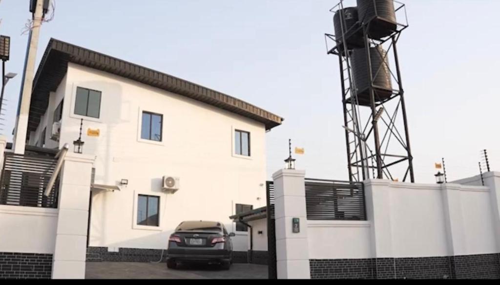 a car parked in front of a building with a windmill at 1bedroom serviced apartment in Benin City in Benin City