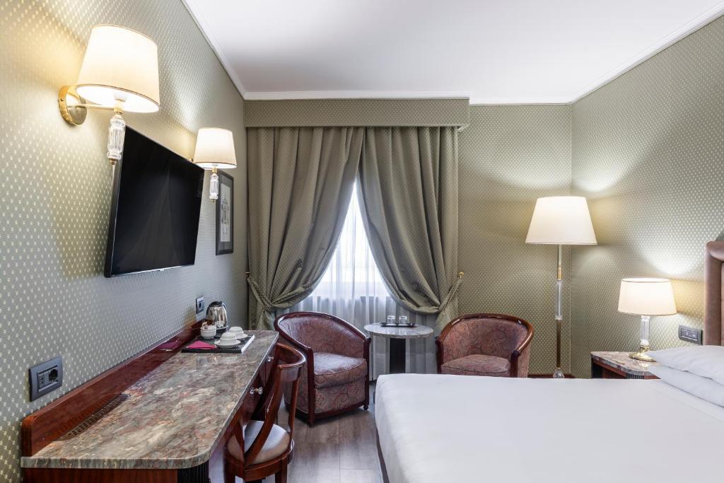 Postel nebo postele na pokoji v ubytování Doria Grand Hotel