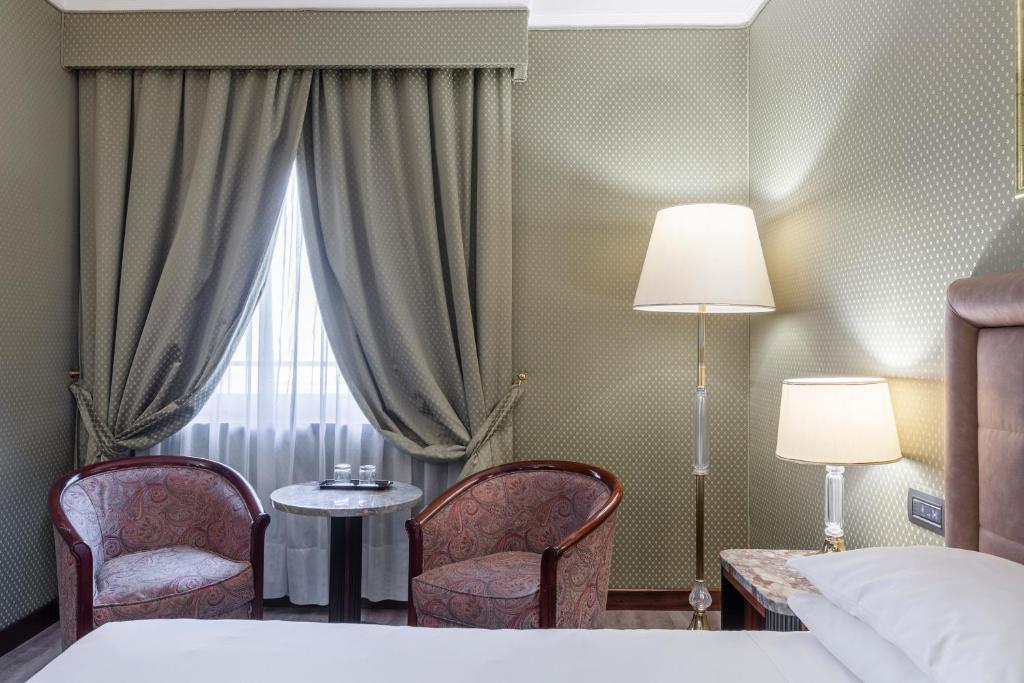 Postel nebo postele na pokoji v ubytování Doria Grand Hotel
