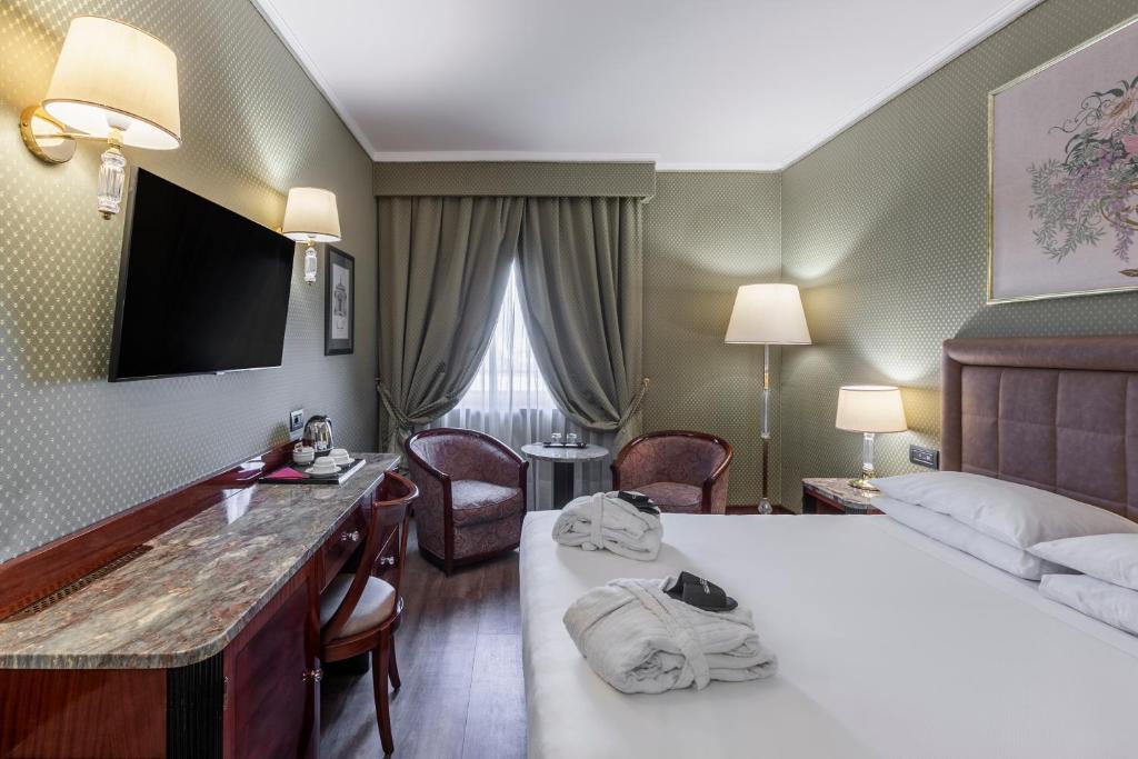 Postel nebo postele na pokoji v ubytování Doria Grand Hotel