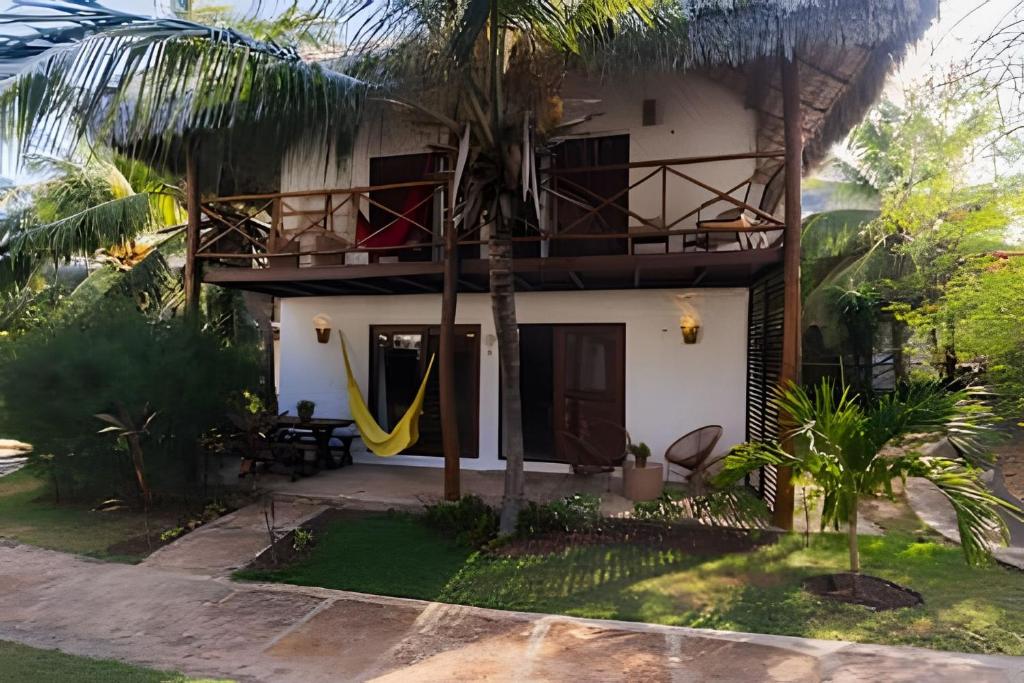 ein Haus mit einer Hängematte davor in der Unterkunft Bangalô da Barra, chalé 04 - BG in Barra Grande