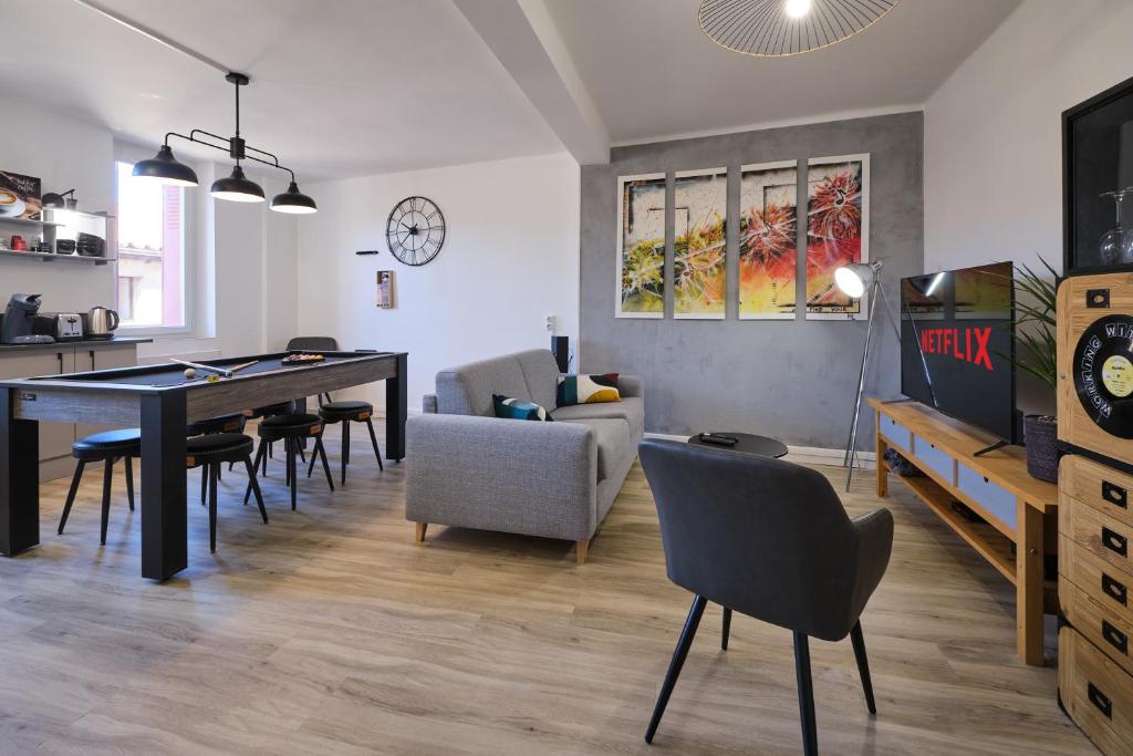 - un salon avec une table de ping-pong et des chaises dans l'établissement Magnifique*T4*centre ville*WIFI*Billard*Netflix*, à Limoux