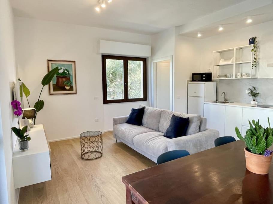 a living room with a couch and a kitchen at Poetto Beach House - Molara1 in Cagliari