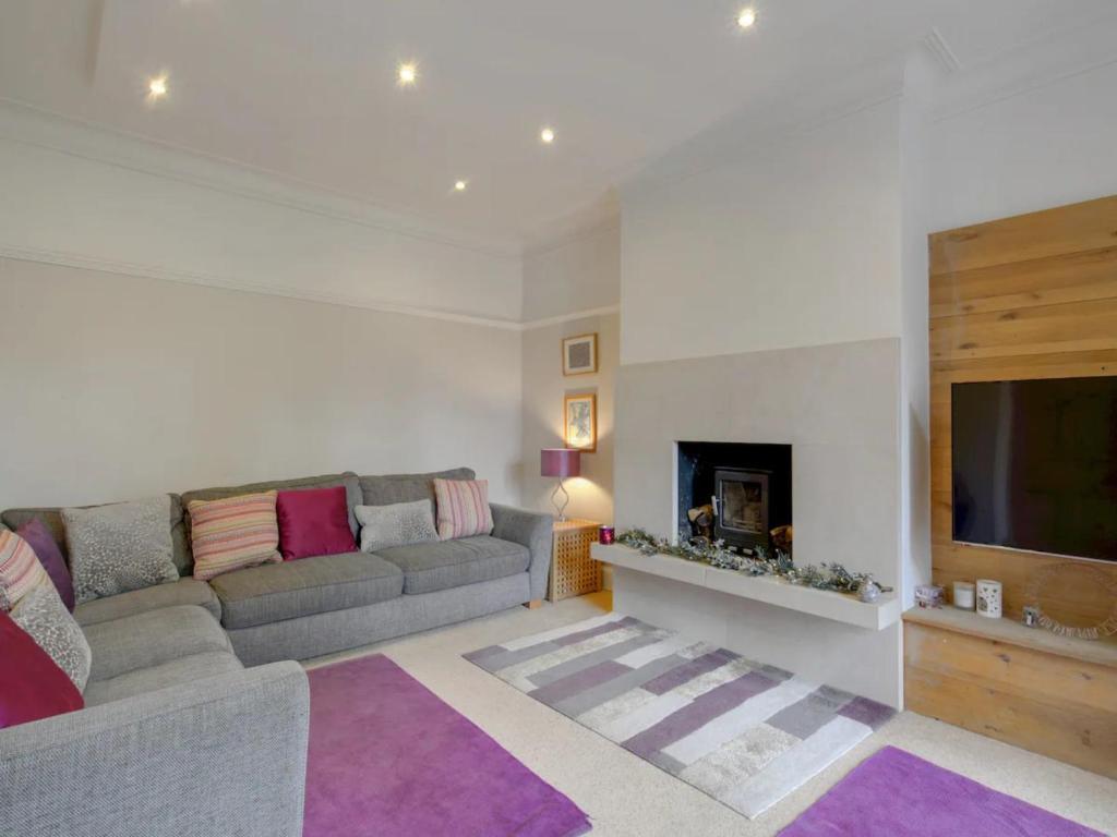 a living room with a couch and a television at Pass the Keys Large Family Home in Cheadle