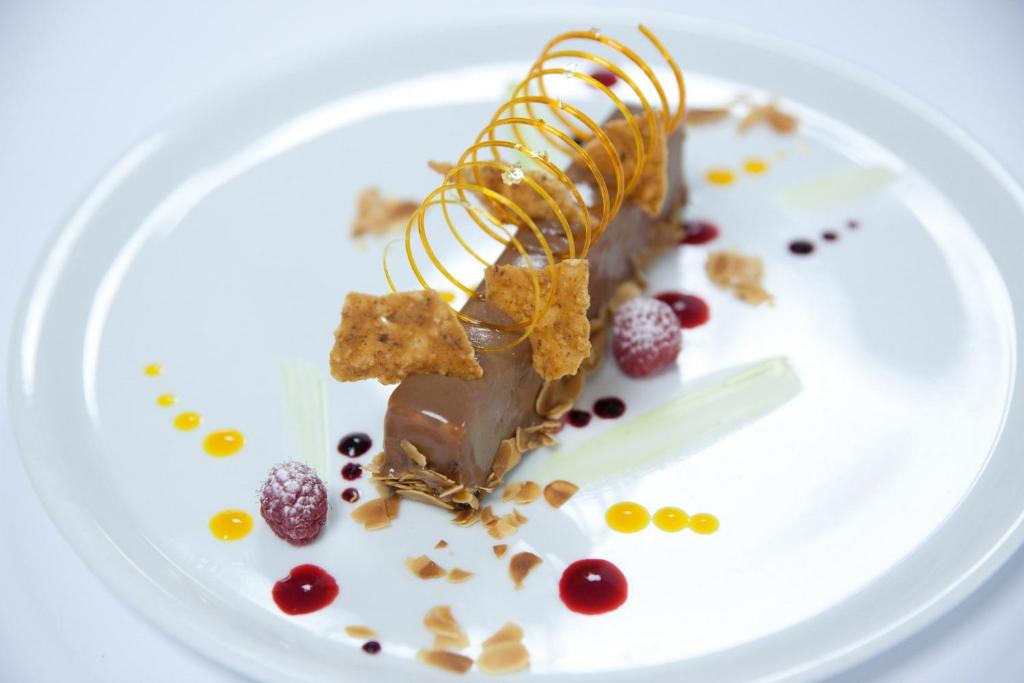 a white plate with a chocolate dessert on it at Hotel Palladia in Toulouse