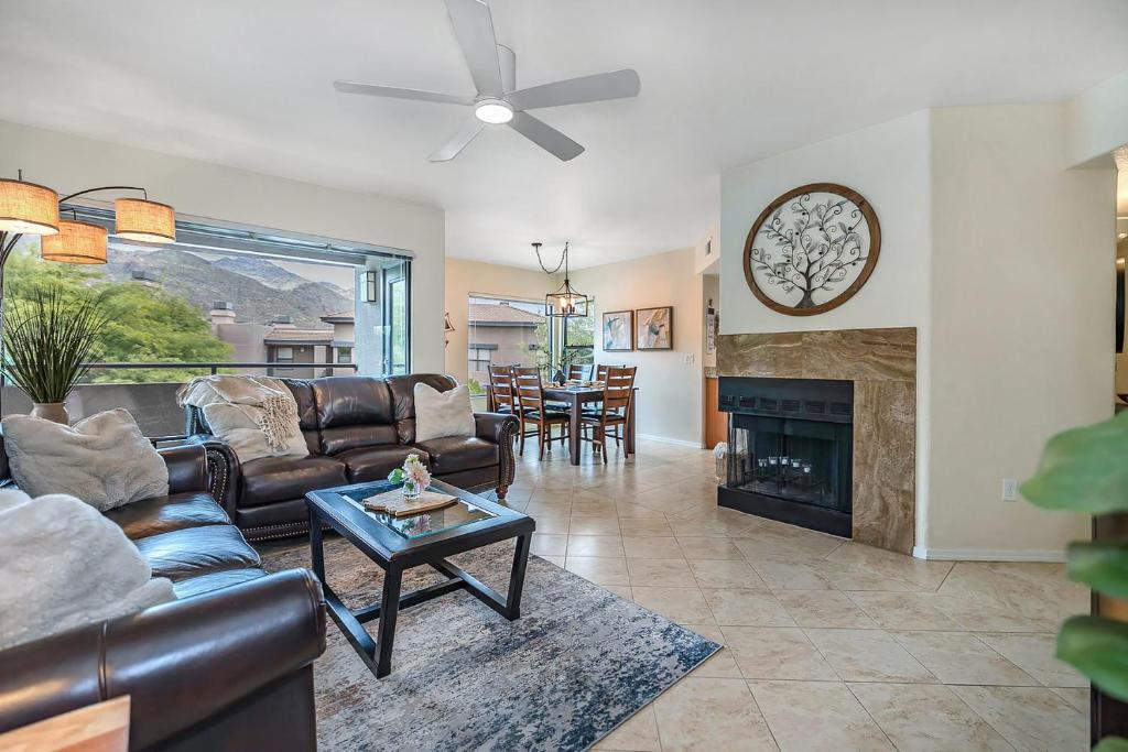 a living room with a couch and a fireplace at Pools / Hot Tub / 3 Bedroom Condo / Ventana Canyon in Tucson