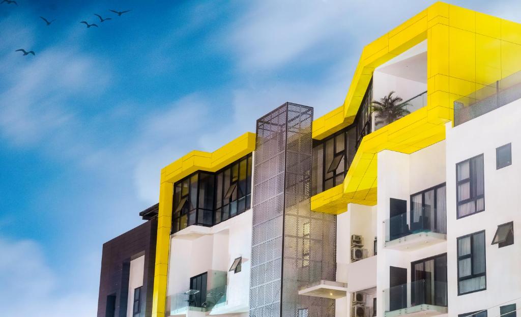 a building with yellow and white at Luxurious 2 Bedroom The Edge Labone in Accra