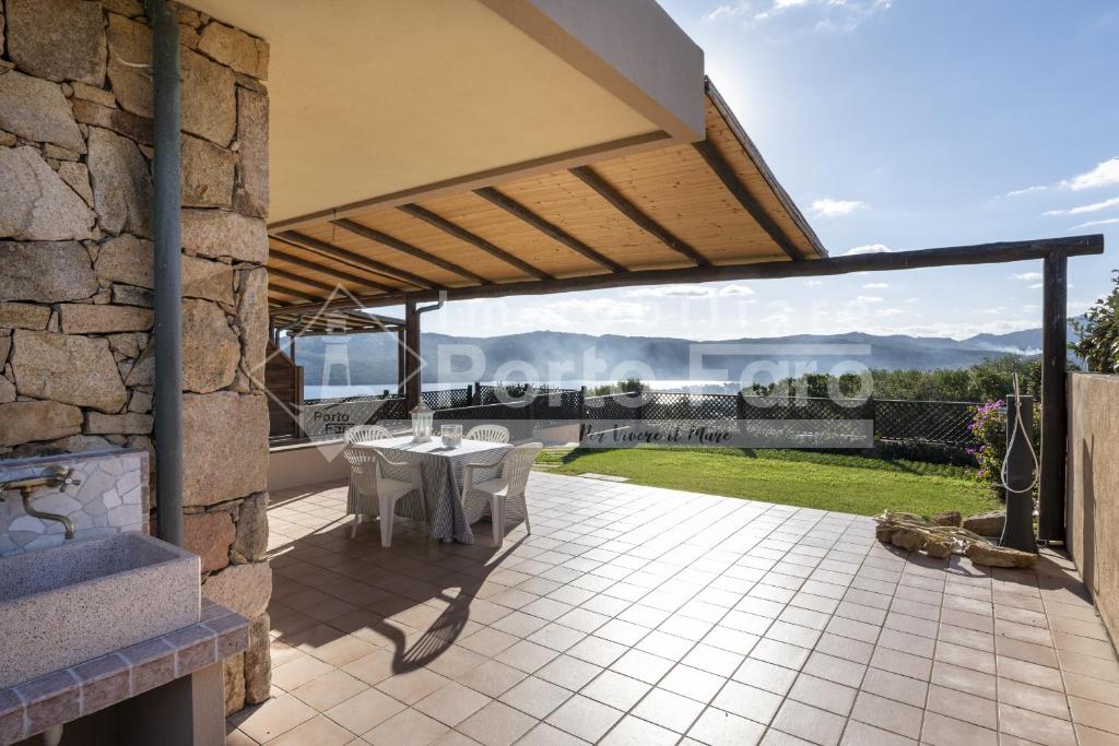 an image of a patio with a table and chairs at L301 - Bilocale caposchiera con giardino e vista sulla spiaggia di Porto Mannu in Palau