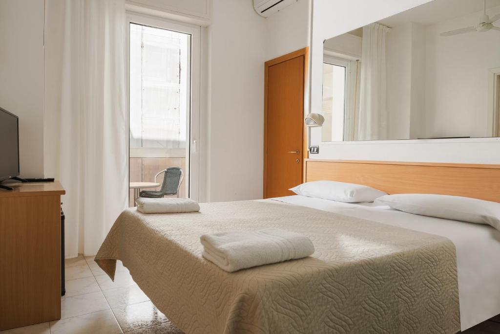 Postel nebo postele na pokoji v ubytování Hotel Leon D'oro