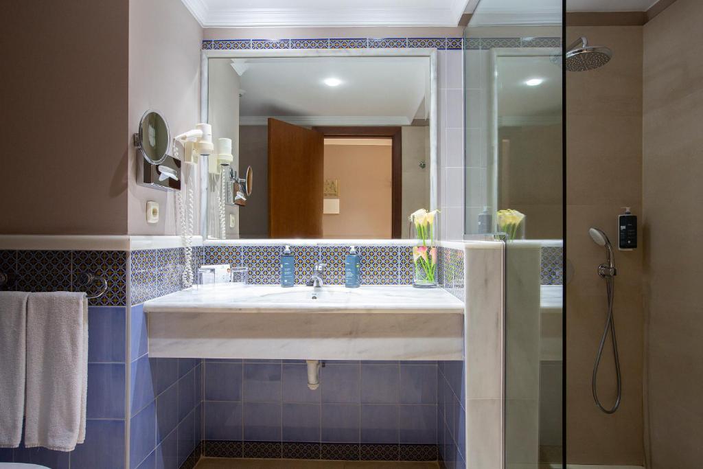 a bathroom with a sink and a mirror at Hipotels Natura Palace Adults Only in Playa Blanca